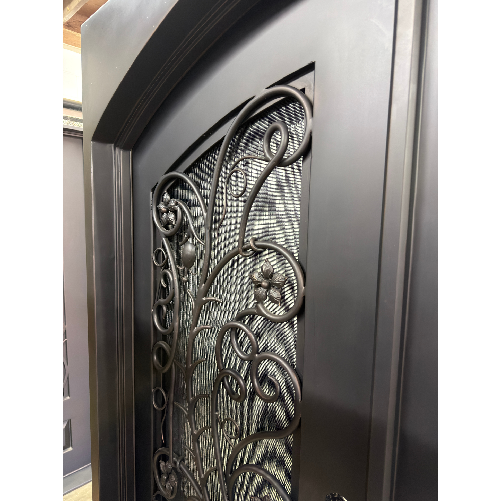 Decorative metal door with intricate designs and a textured finish.