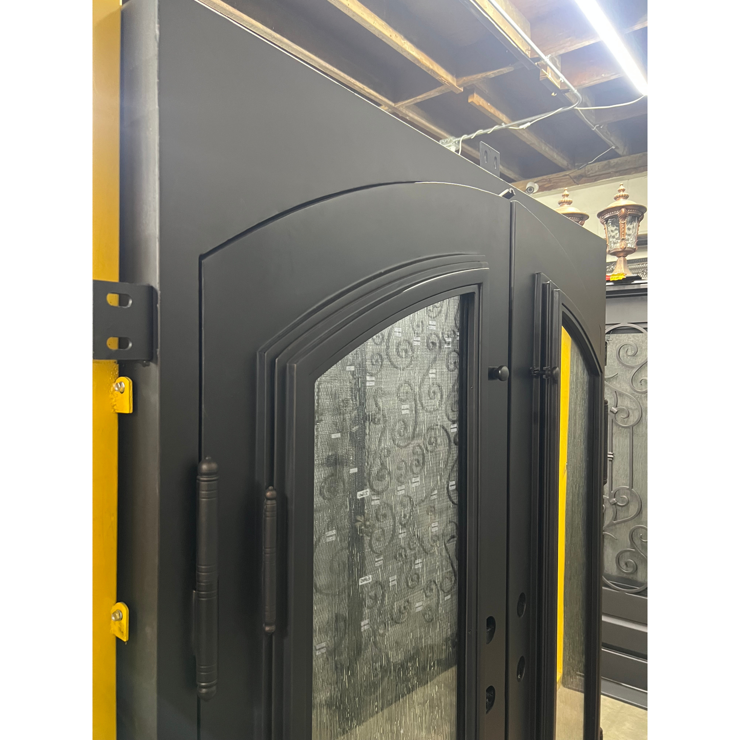 Modern black door with glass panels in a warehouse setting