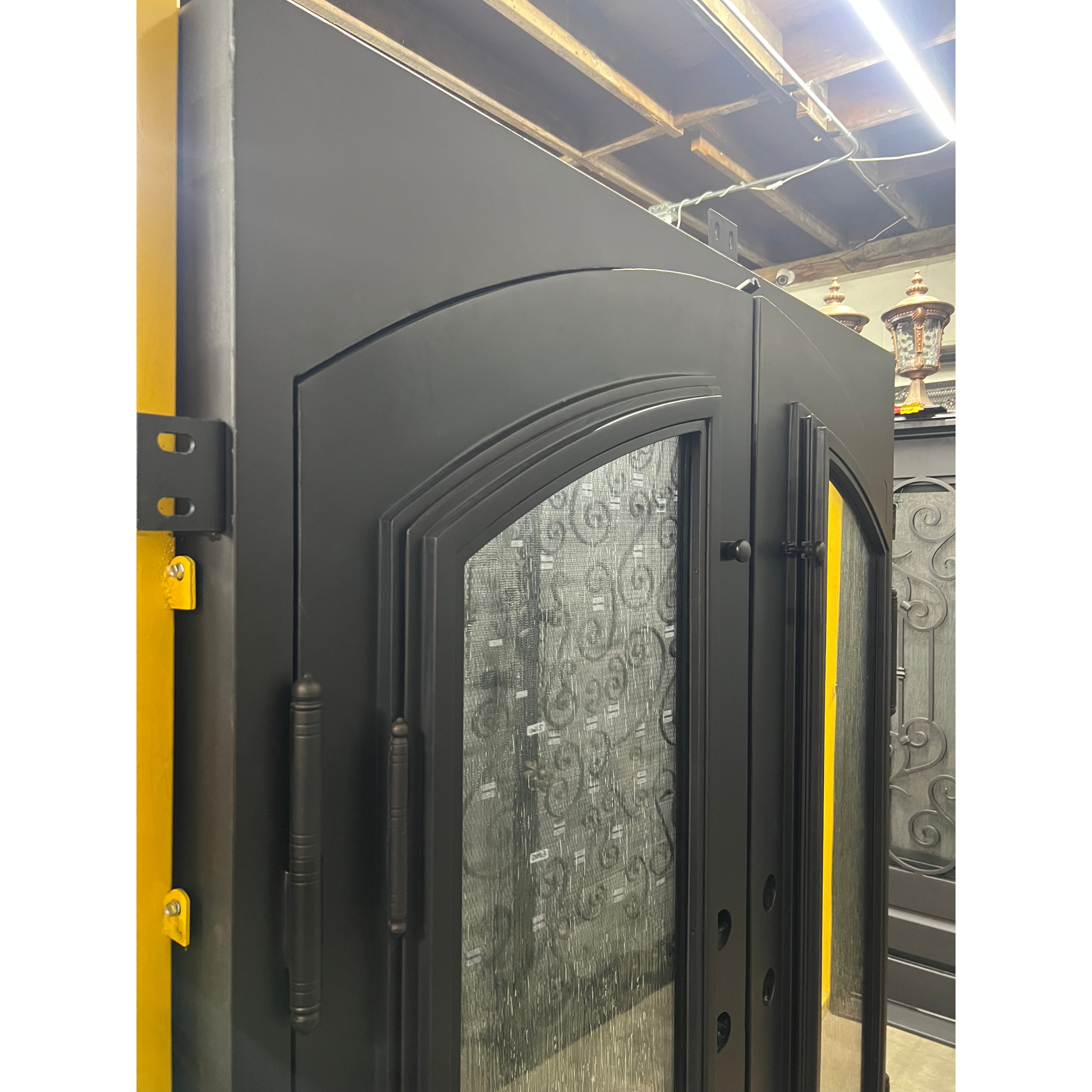 Modern black door with glass panels in a warehouse setting