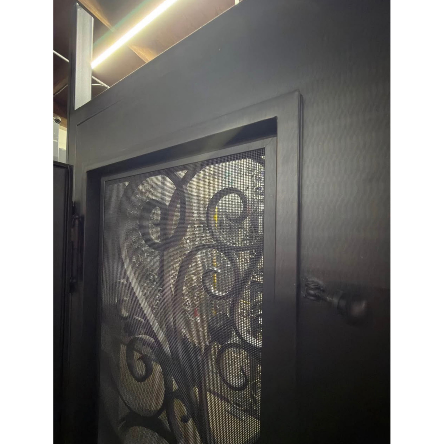 Decorative metal screen door with intricate designs 