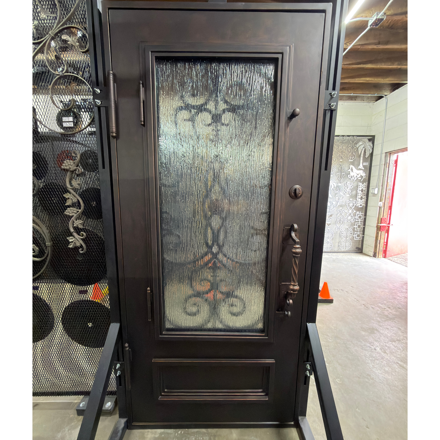 Decorative black door with glass panel in a showroom setting