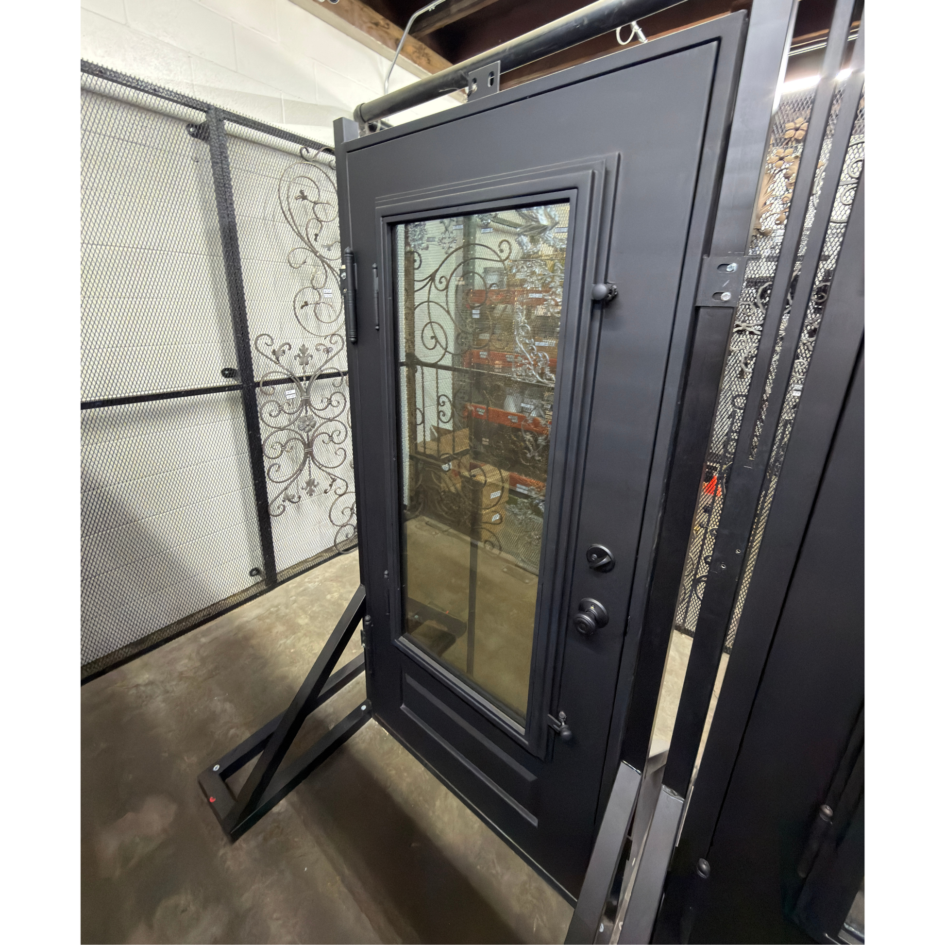 Black metal door with glass panel on display 