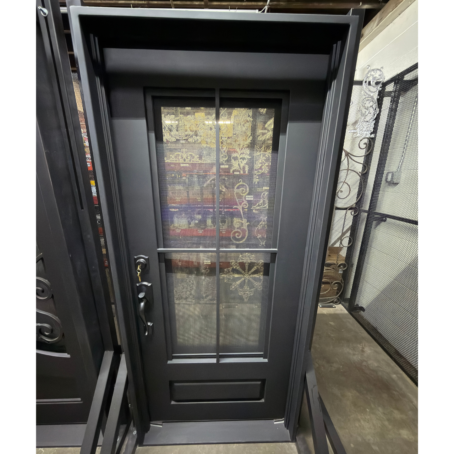 Black metal door with glass panels on a yellow stand