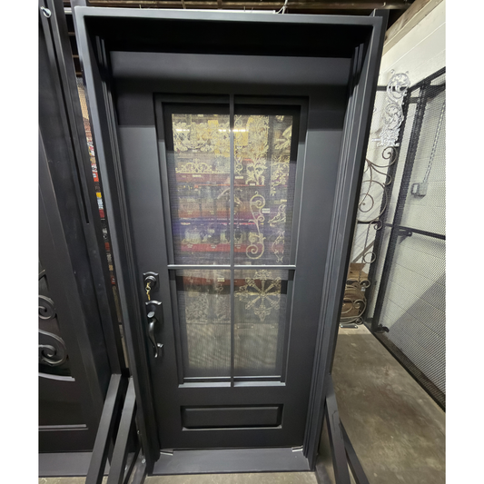 Black metal door with glass panels on a yellow stand