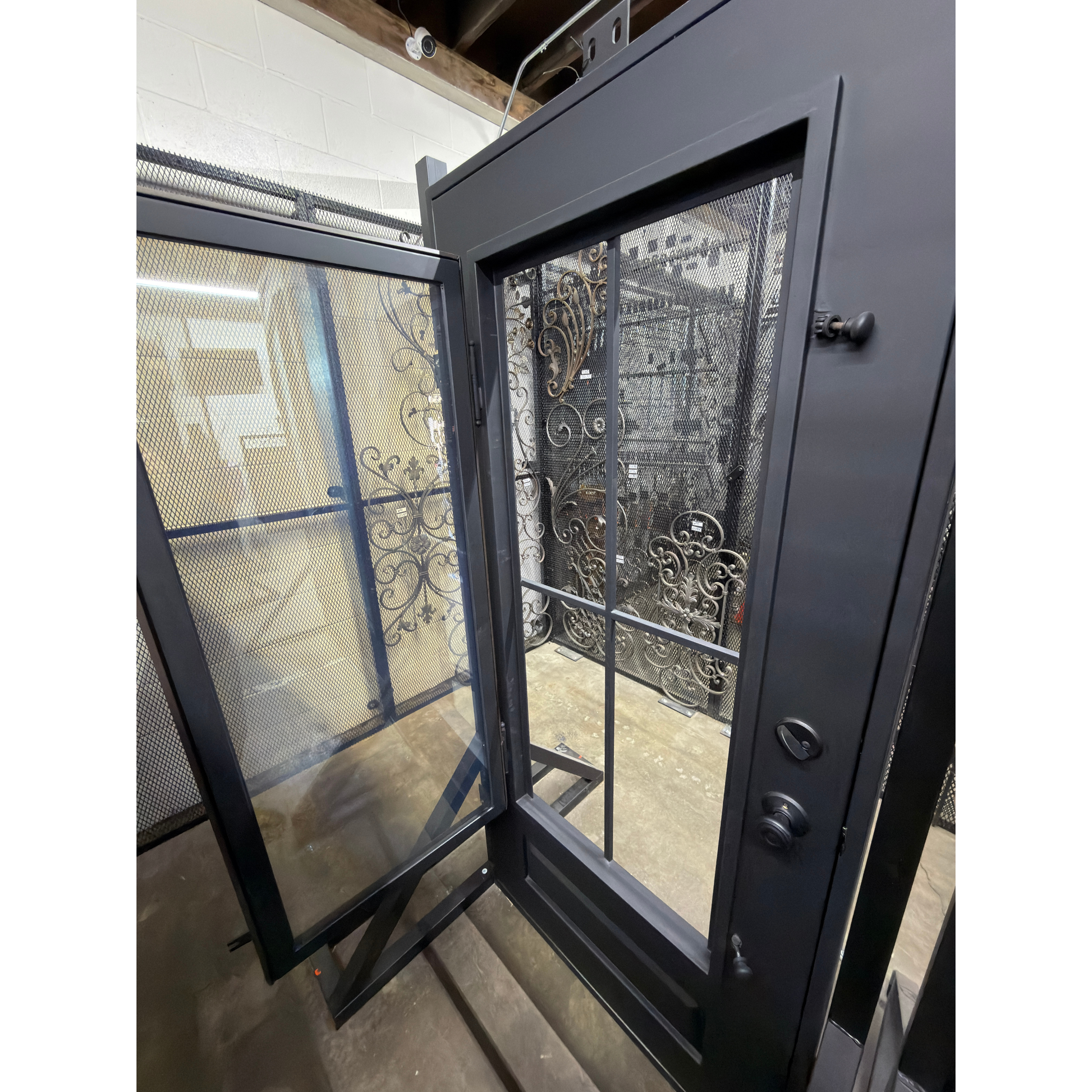 Glass door with a black handle, showing a clear glass window