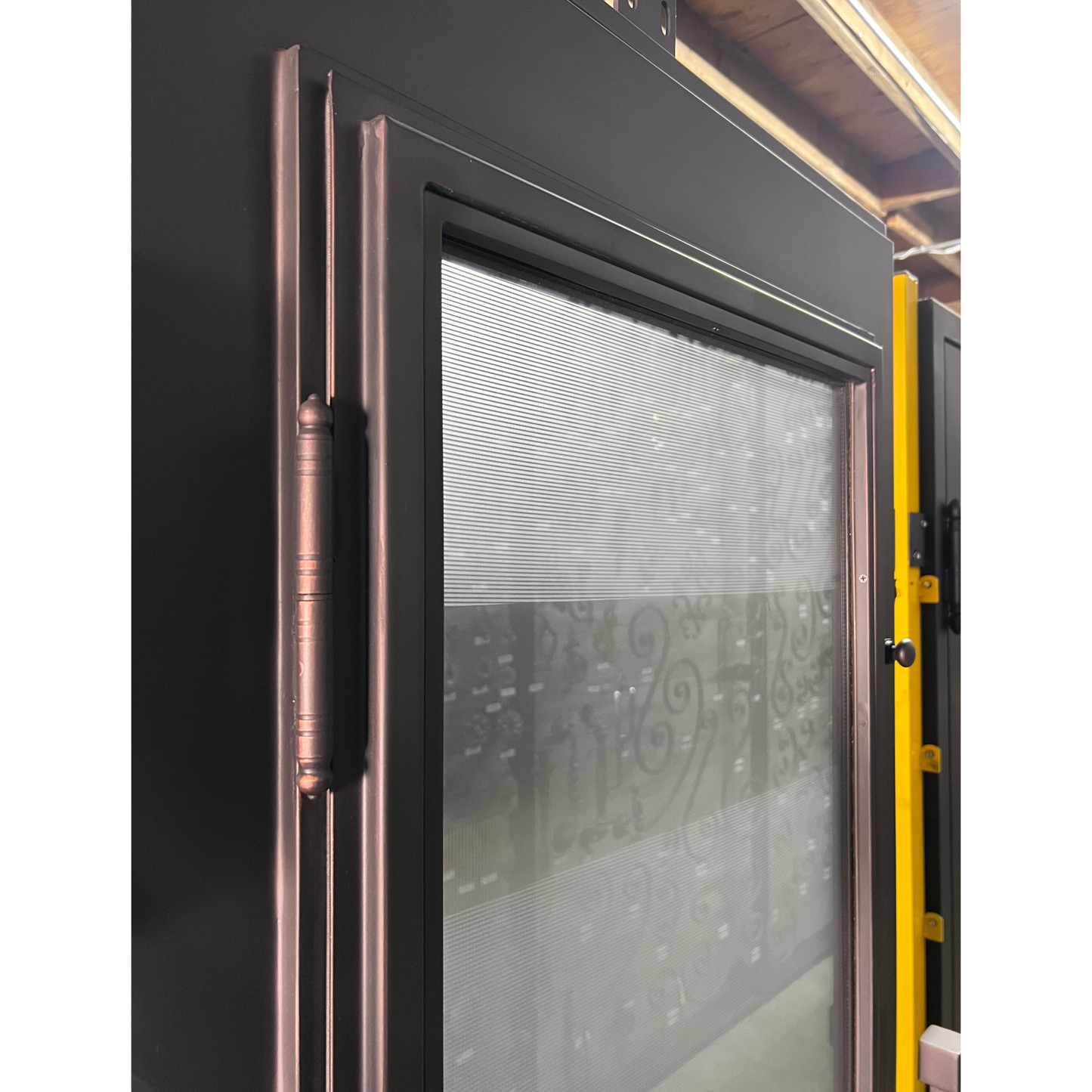 Glass door with decorative handle and patterned glass