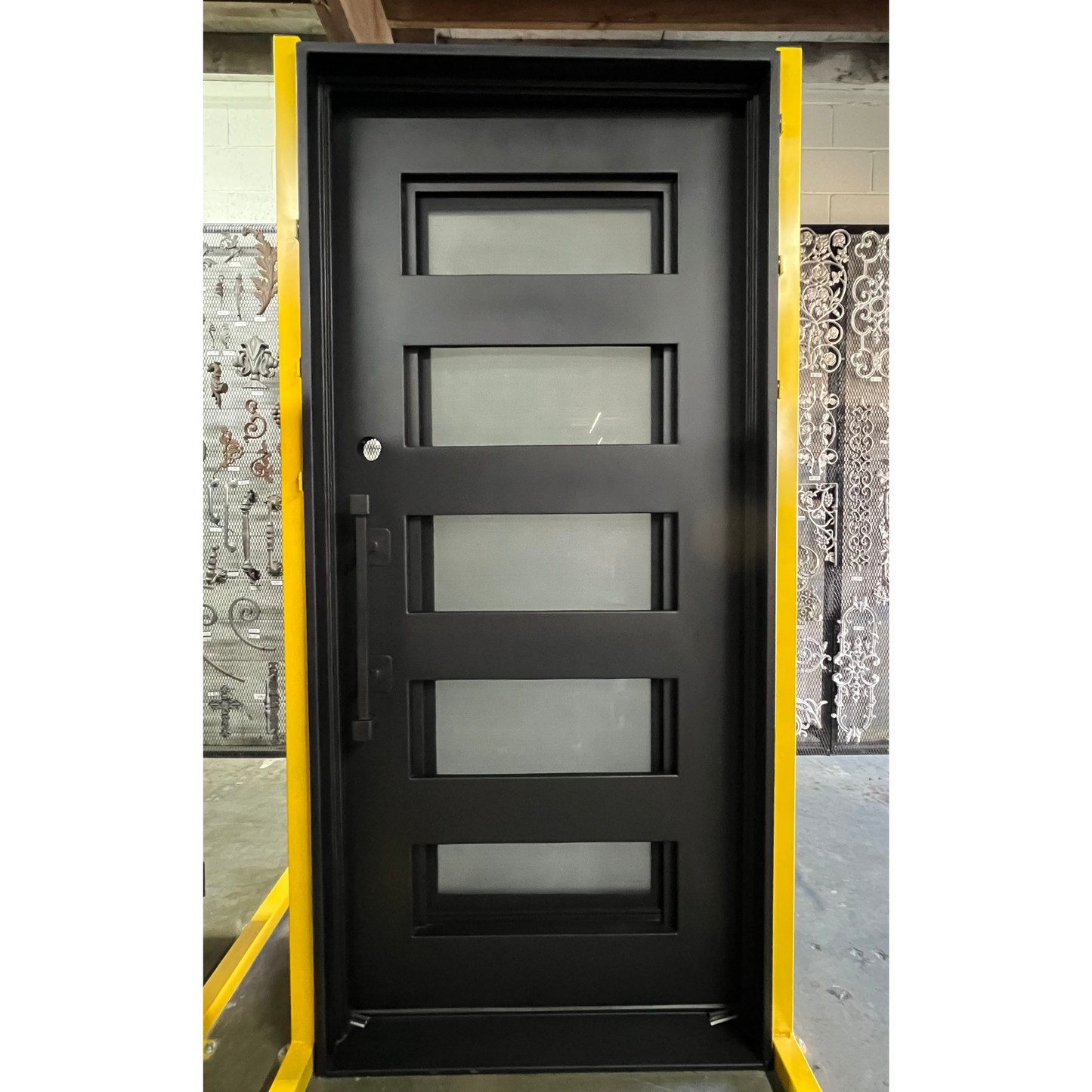 Black door with glass panels in a warehouse setting