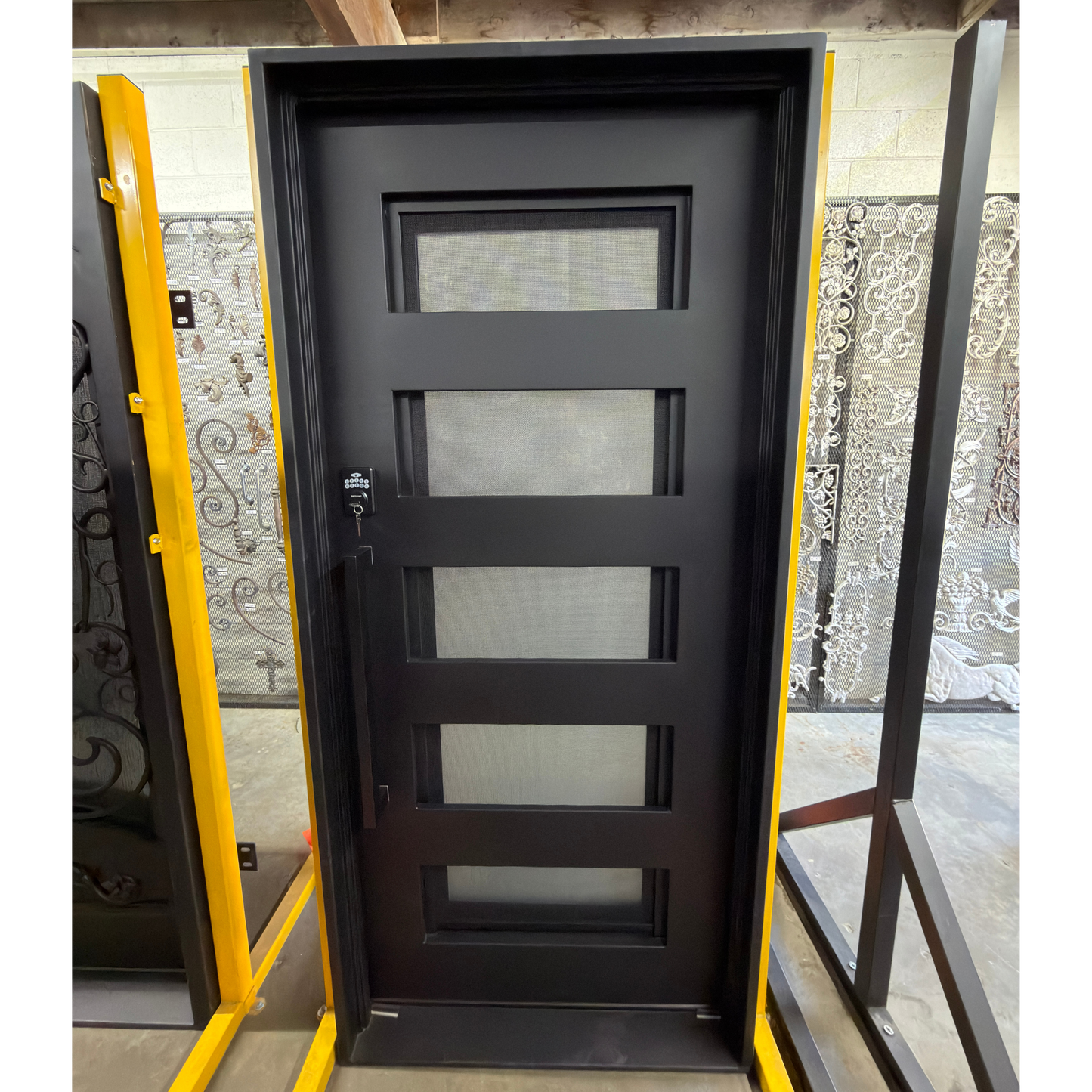Black exterior door with glass panels on a white background