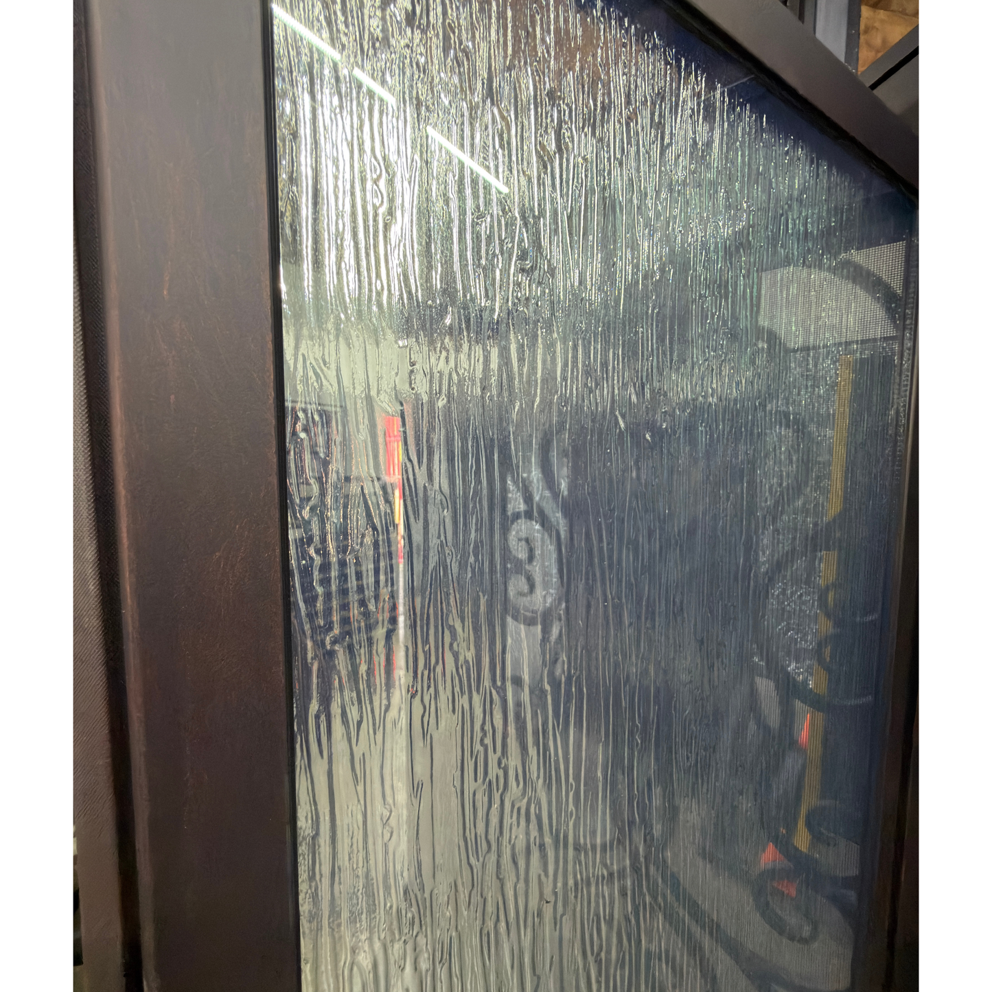 Rain glass with decorative ironwork and colorful lights inside a building
