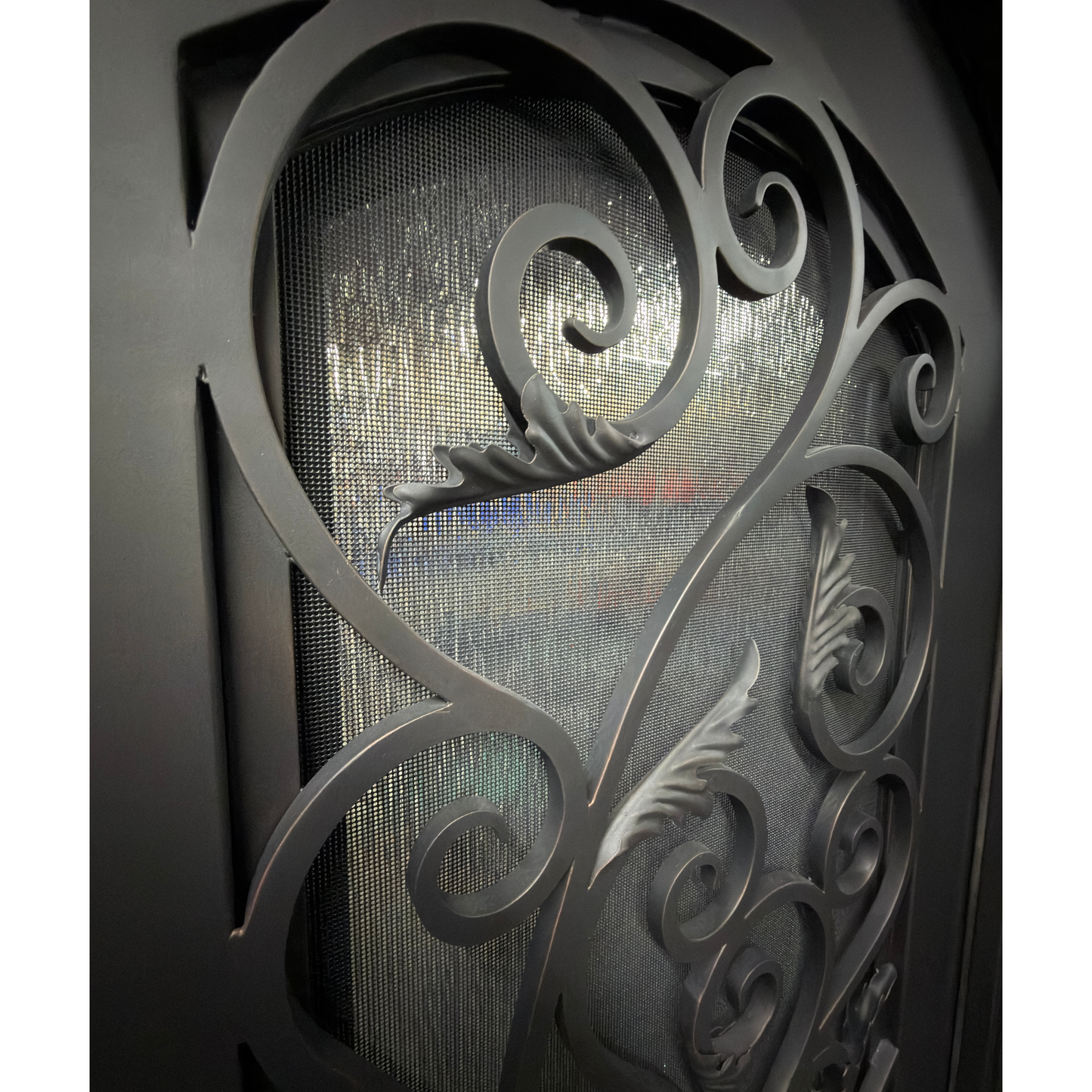 Decorative metal gate with intricate designs on a yellow background
