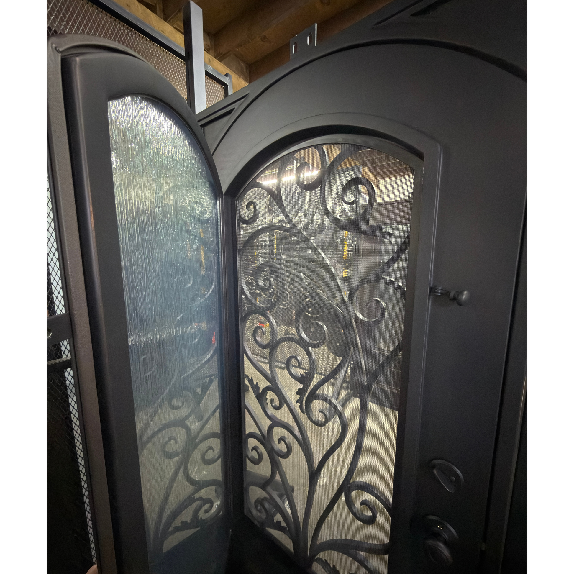 Decorative glass door with intricate metalwork in a home setting