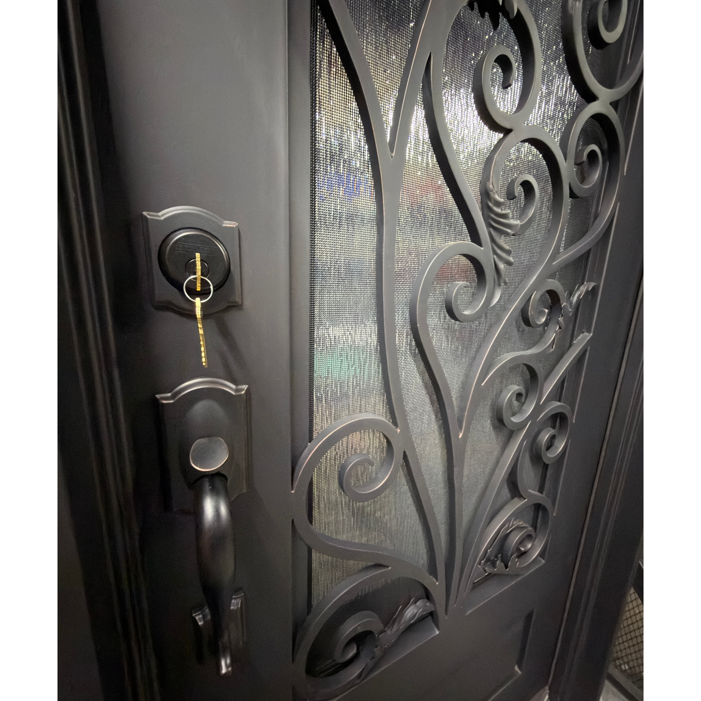 Decorative metal door with intricate designs and a key lock mechanism.